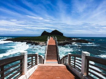 Pier over sea against sky