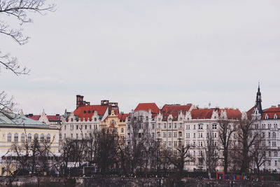 Buildings in city against clear sky