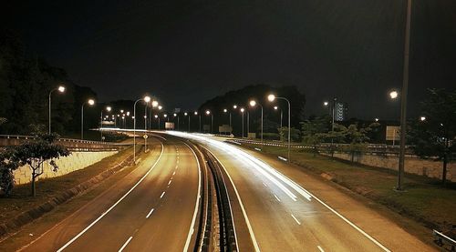 Light trails on road in city at night