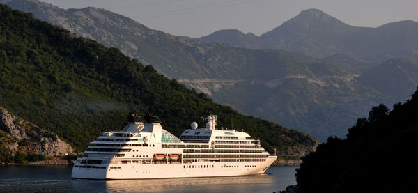 Scenic view of cruise ship against mountains