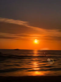 Scenic view of sea against romantic sky at sunset