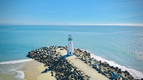 Scenic view of sea and light house against sky