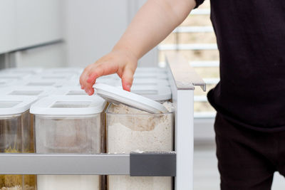 Child picking an item from storage drawer. the kitchen organization concept