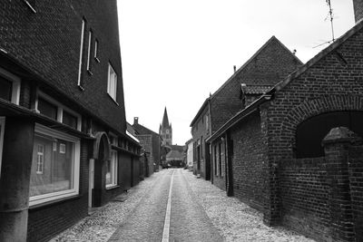 Narrow alley amidst buildings against sky