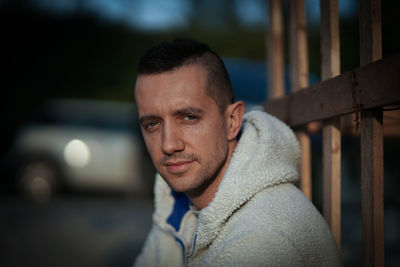 Close-up portrait of smiling man sitting outdoors