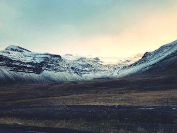 Scenic view of snowcapped mountains against sky