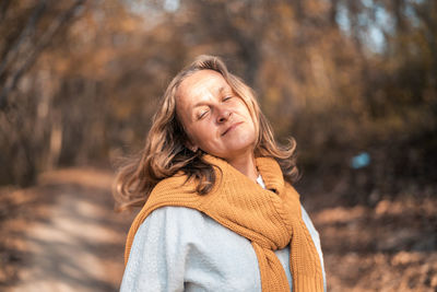 Portrait of woman wearing sunglasses standing outdoors during autumn