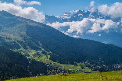 Scenic view of landscape and mountains against sky