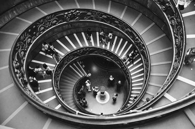 High angle view of people on spiral staircase in building