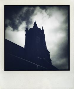 Low angle view of built structure against cloudy sky