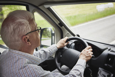 Senior man driving van