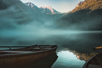 Scenic view of lake by mountains against sky