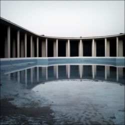 View of swimming pool by sea against clear sky