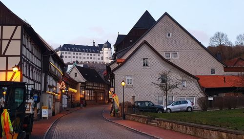 Road amidst buildings against sky in city