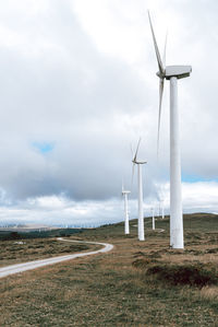 Windmill on field against sky