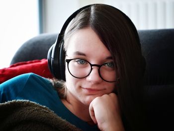 Close-up of young woman sitting in sofa