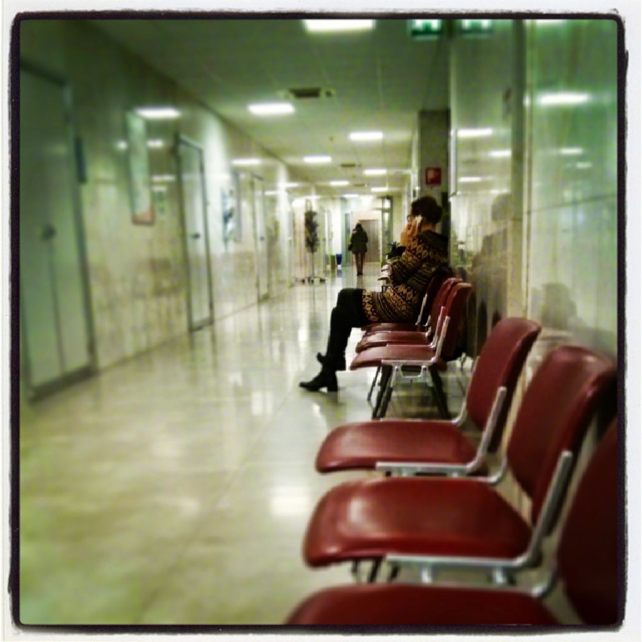 REAR VIEW OF MAN SITTING ON ESCALATOR