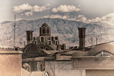 Exterior of old building by mountains against sky