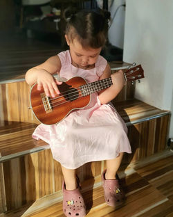 Portrait of girl playing guitar