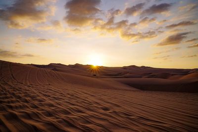 Scenic view of desert against sky during sunset