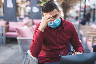 Worried and depressed man with face mask