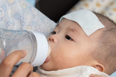 Portrait of cute boy drinking water from bottle