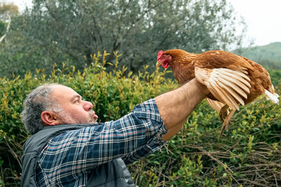 Man holding hen