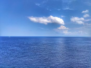 Scenic view of sea against blue sky