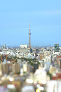 Buildings in city against clear sky