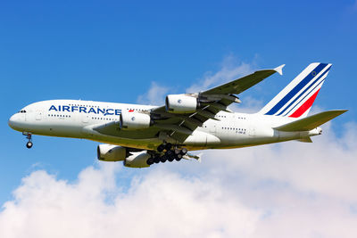 Low angle view of airplane flying against sky