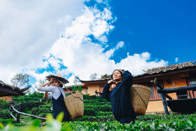 Female farmers standing at farm