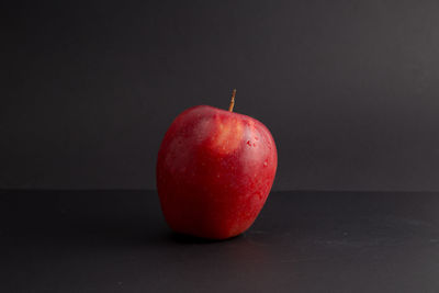 Close-up of apple against black background