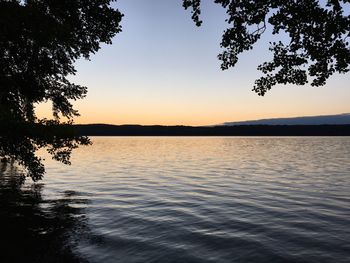 Scenic view of lake against sky at sunset