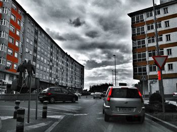 Cars on street against buildings in city