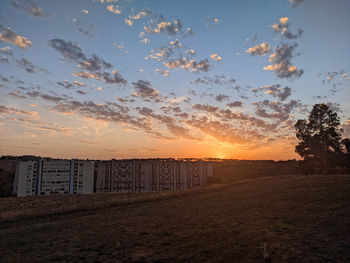 Scenic view of field against sky during sunset