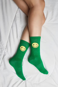 Low section of woman lying on bed