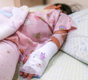 High angle view of woman lying on bed at home
