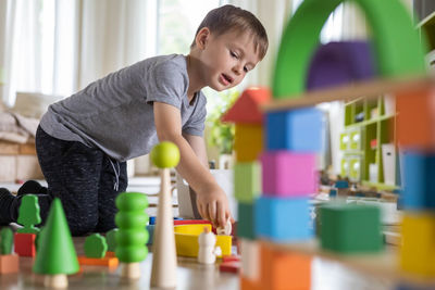 Side view of boy playing in gym