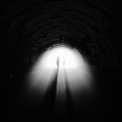 Illuminated tunnel at night