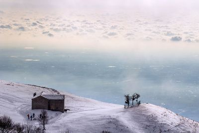 High angle view of snow covered mountain against sky