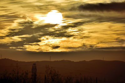 Scenic view of silhouette mountains against sky at sunset