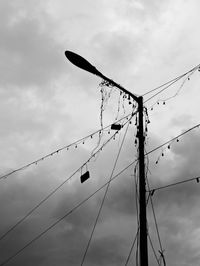 Low angle view of power lines against sky