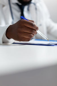 Midsection of doctor examining patient in hospital