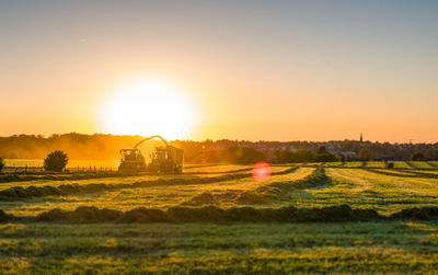 Scenic view of field against sky during sunset