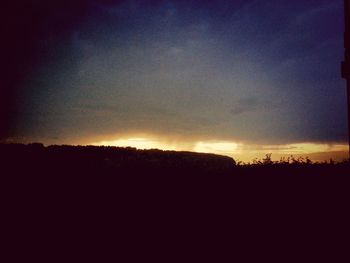 Silhouette landscape against sky during sunset