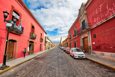 Street amidst buildings against sky