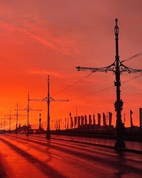 Silhouette of  street lampposts on the trinity bridge against sky during sunset 