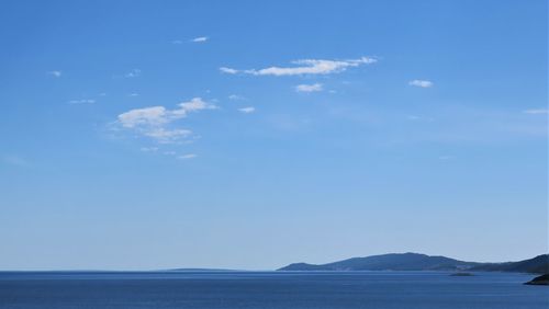 Scenic view of sea against blue sky