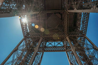 Bottom view of art nouveau style eiffel tower and sunlight in paris. the famous capital of france.