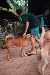 Full length of man with dog standing outdoors